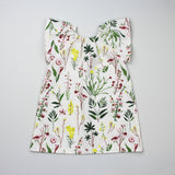 Back of Peasant Dress Sewing Pattern in Wild Flower Print on Grey Background