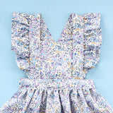 close up of ruffle pinafore dress in which you can see the strap details