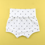 back of Fold over baby bummie shorts in an x fabric on a yellow background