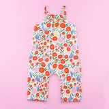 Back of Poppy Romper Pattern with Ruffles and Snaps on Pink Background