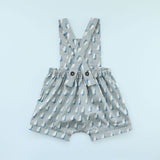 Back of Rainy Day Romper in raindrop print on blue background