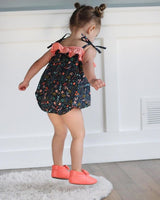 Girl Jumping in Her Bubble Romper and Pink Moccasins