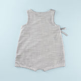 Back of Sleeveless Wrap up Romper on a Light Blue Background