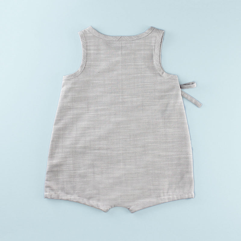 Back of Sleeveless Wrap up Romper on a Light Blue Background