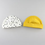 Mustard yellow and star baby hats with the band folded