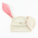 baby hat with bunny ears in white and pink knit fabrics.