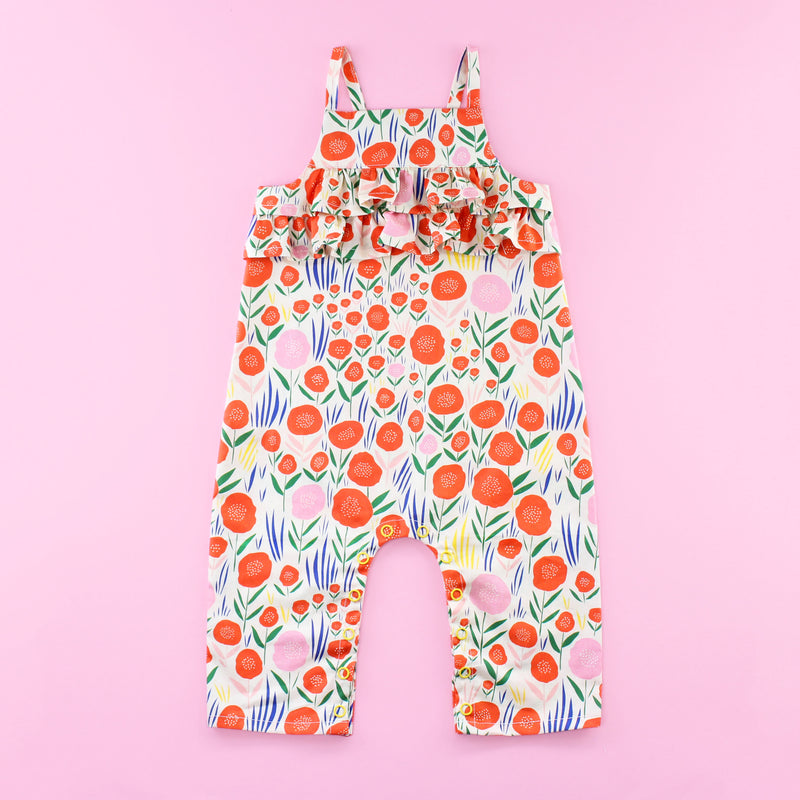 Poppy Romper Pattern with Ruffles and Snaps on Pink Background