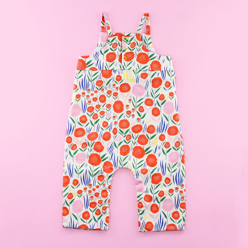 Back of Poppy Romper Pattern with Ruffles and Snaps on Pink Background