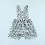 Back of Rainy Day Romper in raindrop print on blue background