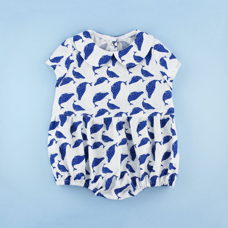 peter pan collar romper pattern with polka dot whales on a blue background
