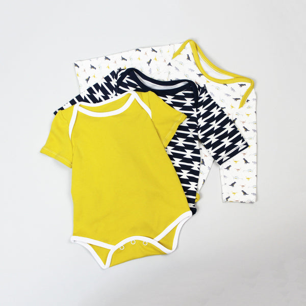 three baby onesies layered on top of each other