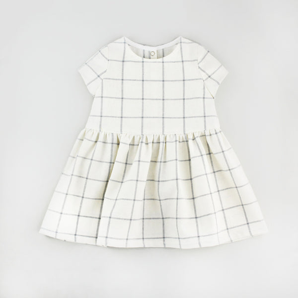 Modern Check Baby Dress Sewing Pattern on a Grey Background