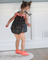 Girl Jumping in Her Bubble Romper and Pink Moccasins 