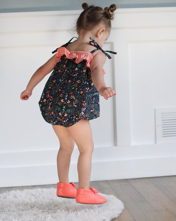 Girl Jumping in Her Bubble Romper and Pink Moccasins 